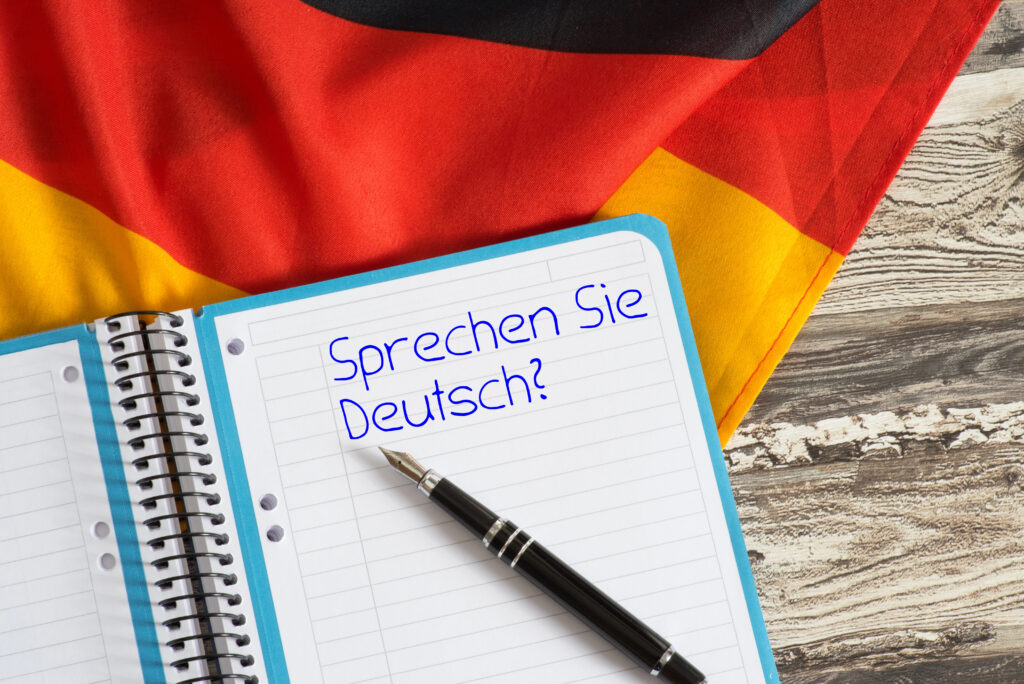 Зошит із написом Sprechen Sie Deutsch та прапор Німеччини