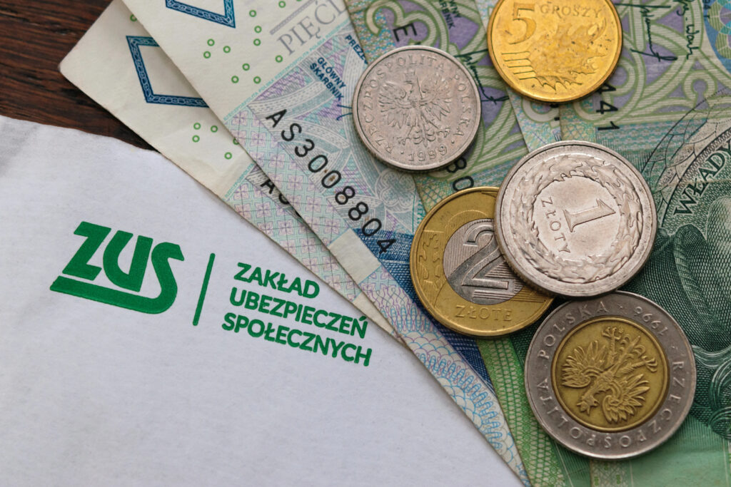Польські монети й банкноти на документі з логотипом ZUS